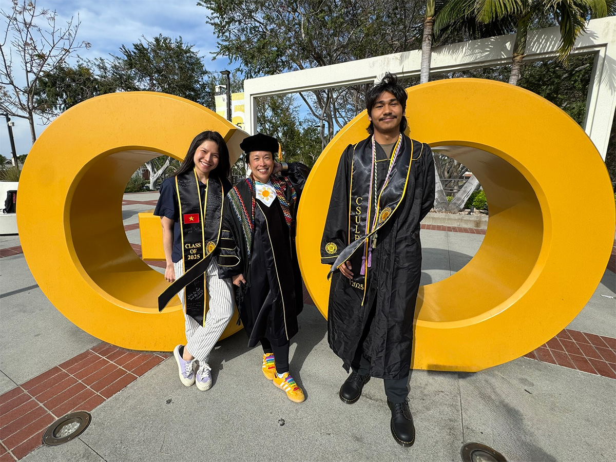 Chemistry scholars and mentors in front of the Go Beach sign
