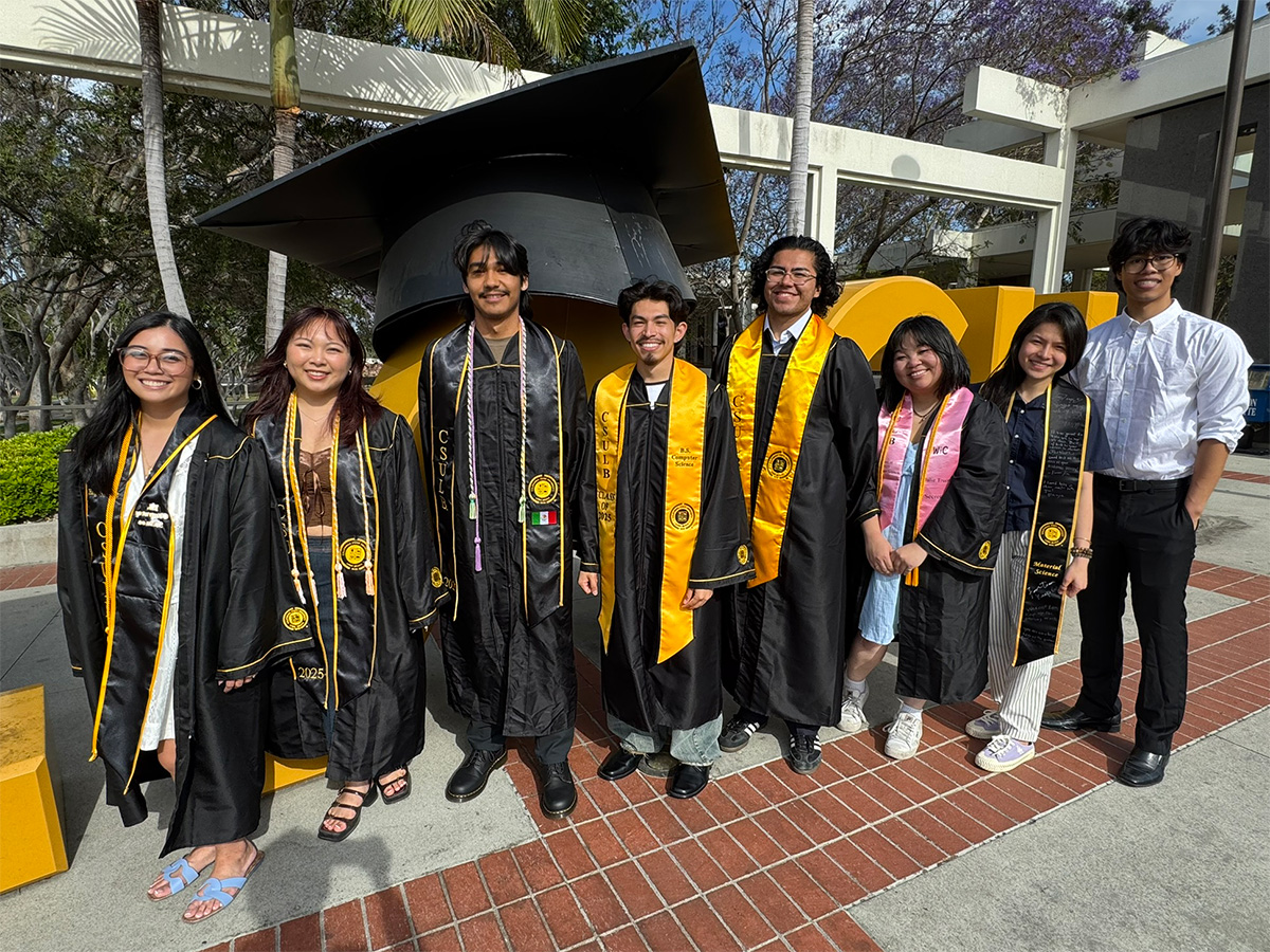 2025 METRIC graduates in front of Go Beach sign