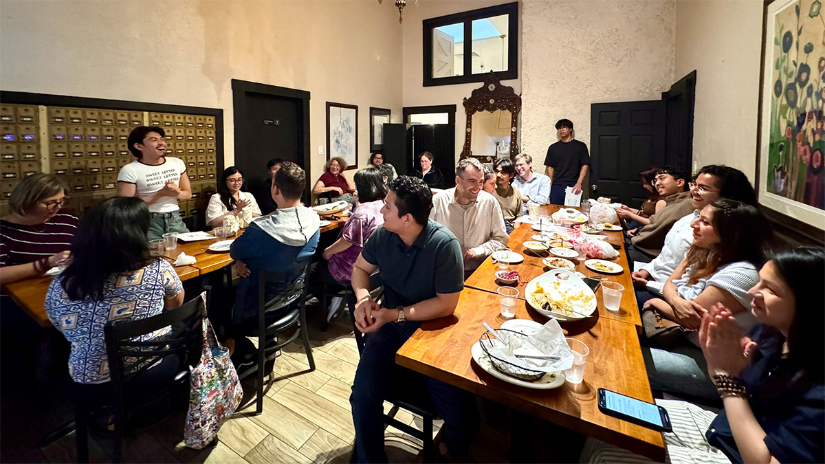 METRIC graduate Oswaldo giving a speech at dinner