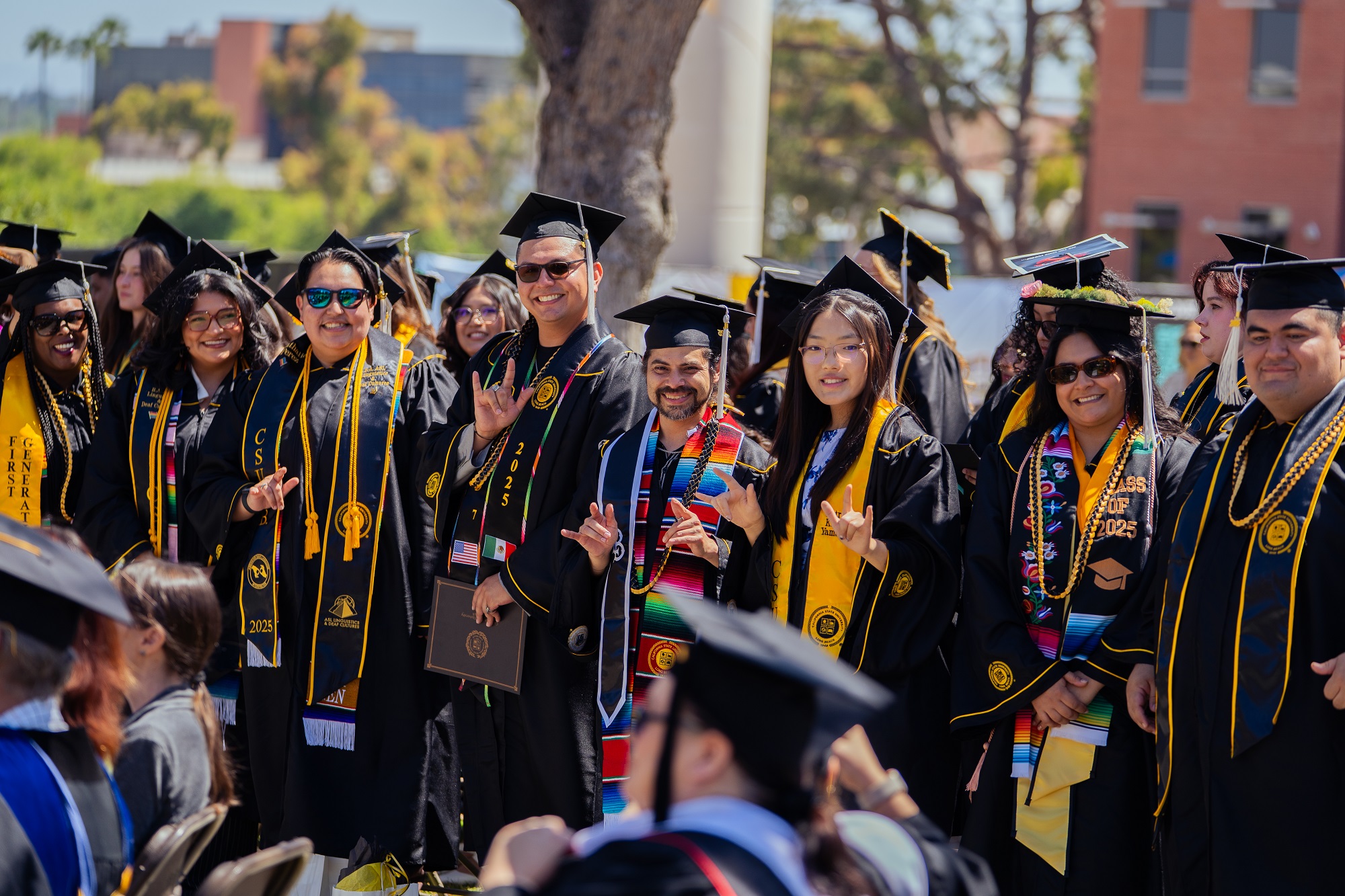 2025 Linguistics Graduation Students Waving
