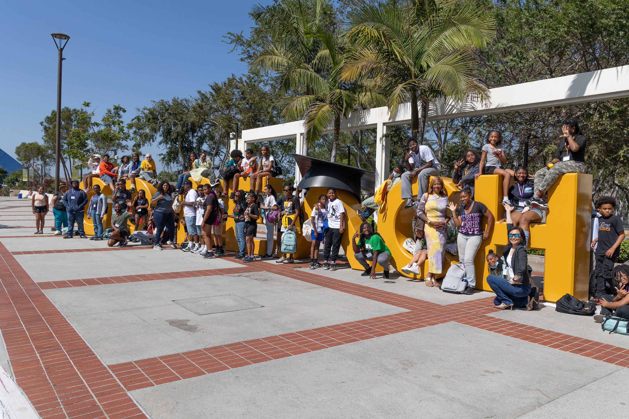 Students in front of the Go Beach sign