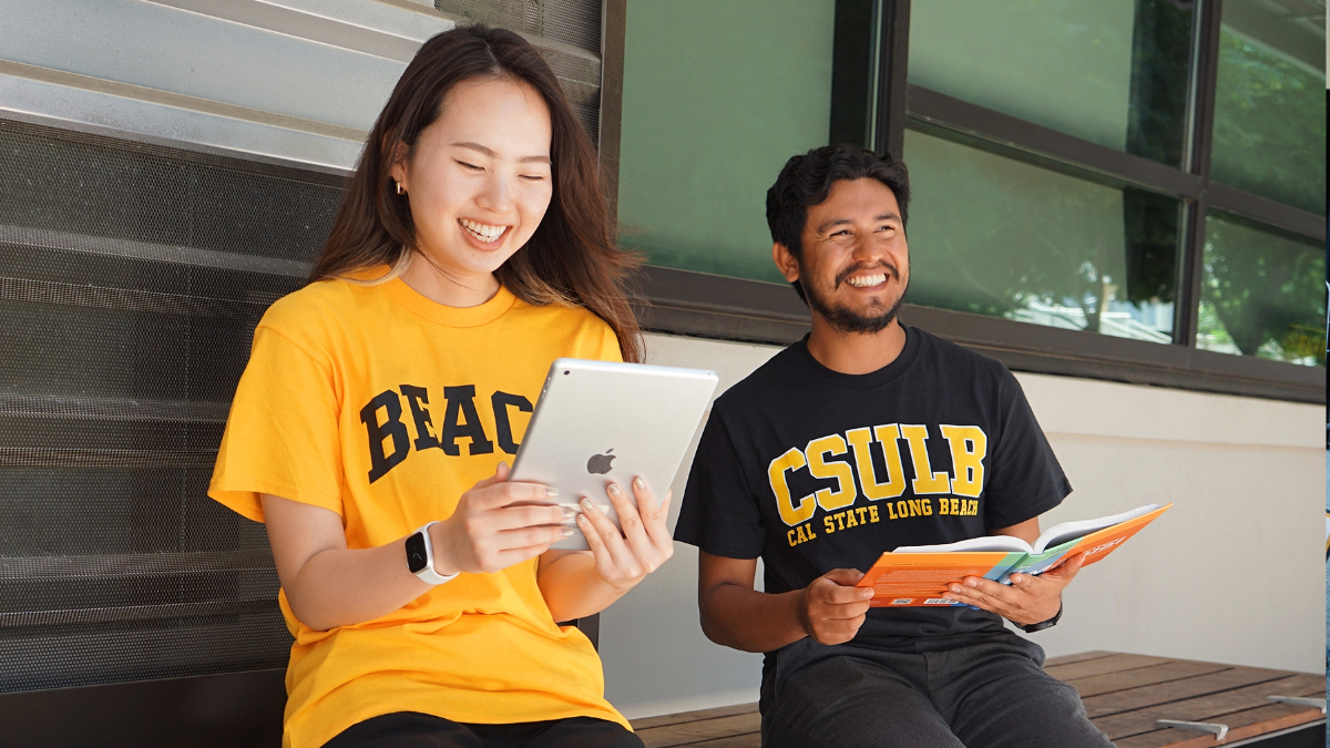 Two CSULB students enjoying their textbooks