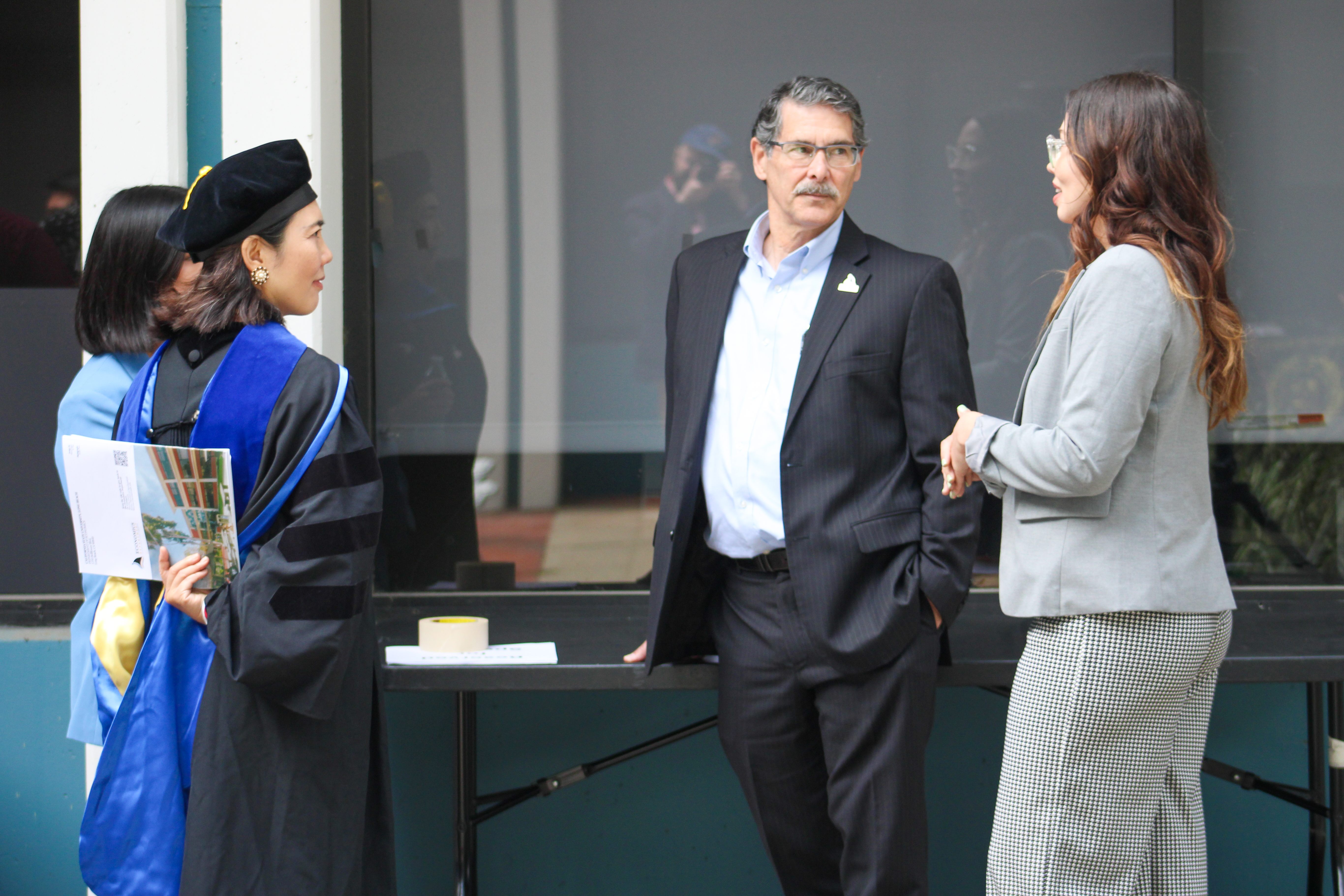 OER Faculty Researchers, Dr. Kleinhenz and Megan Anaya talking with Econ Faculty, Dr. Chen and Dr. Garcia.