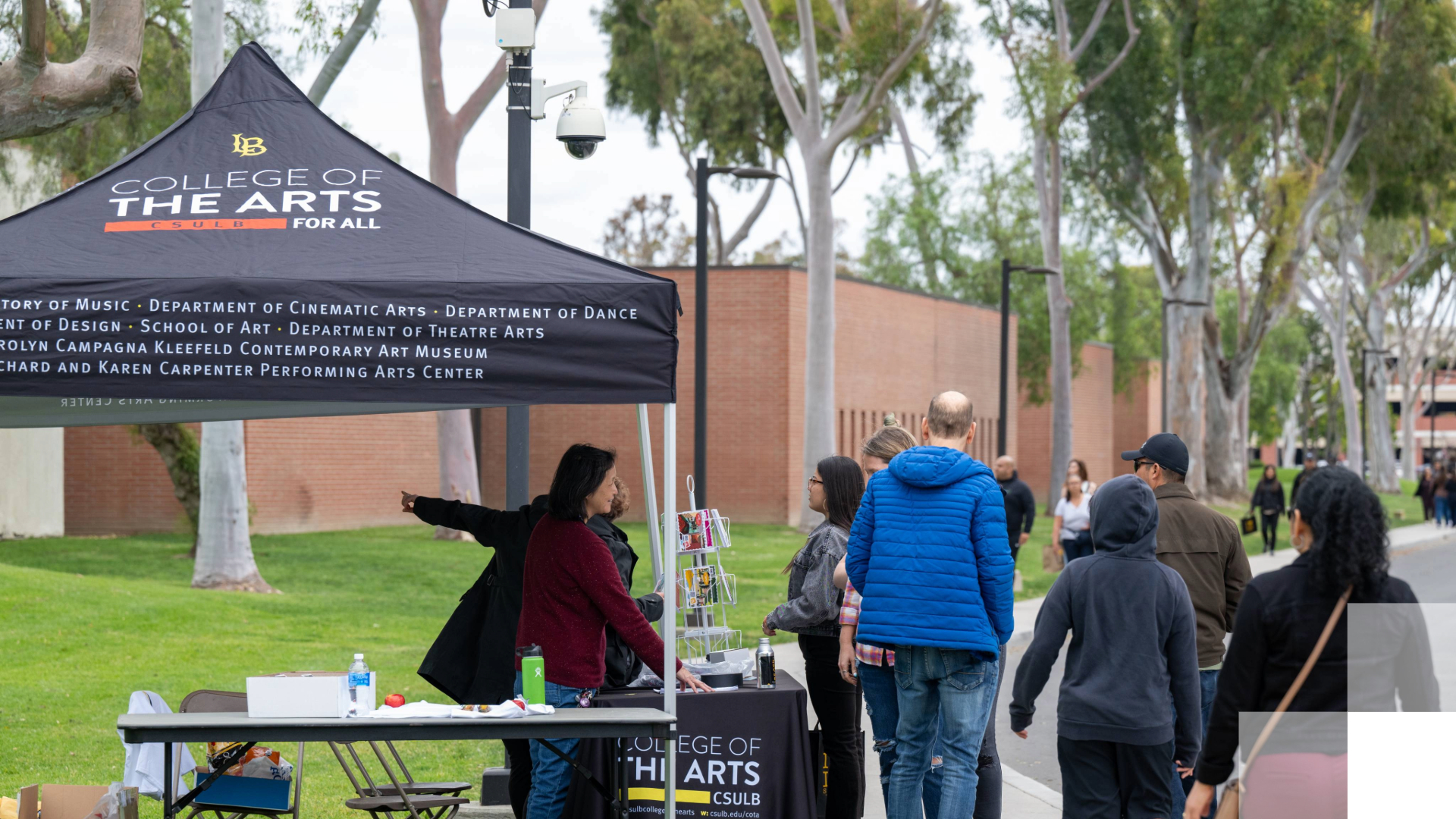 Abstraction Symposium People visiting a College of the Arts booth outdoors on campus