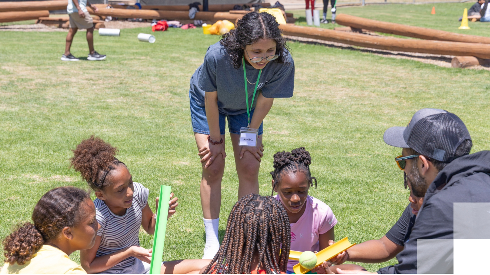 Children and adults doing an outdoor activity on grass Children and adults doing an outdoor activity on grass