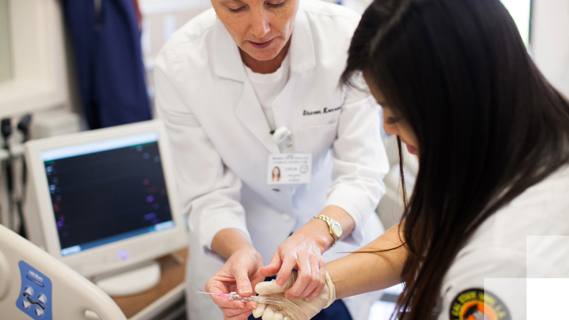 Reimagine Faculty Instructor guiding a nursing student in a clinical procedure