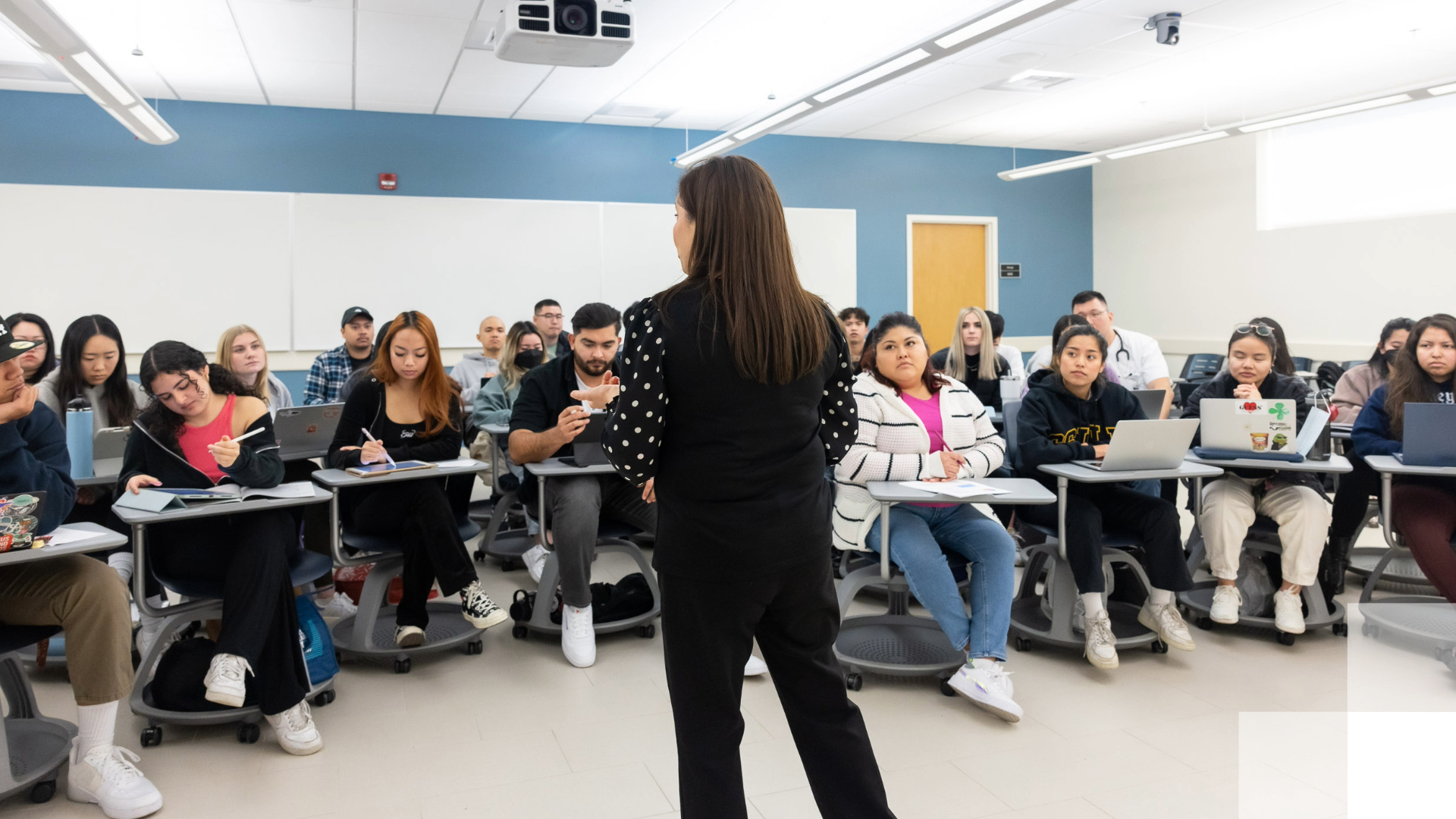 Instructor speaking to students in a classroom. Instructor speaking to students in a classroom.