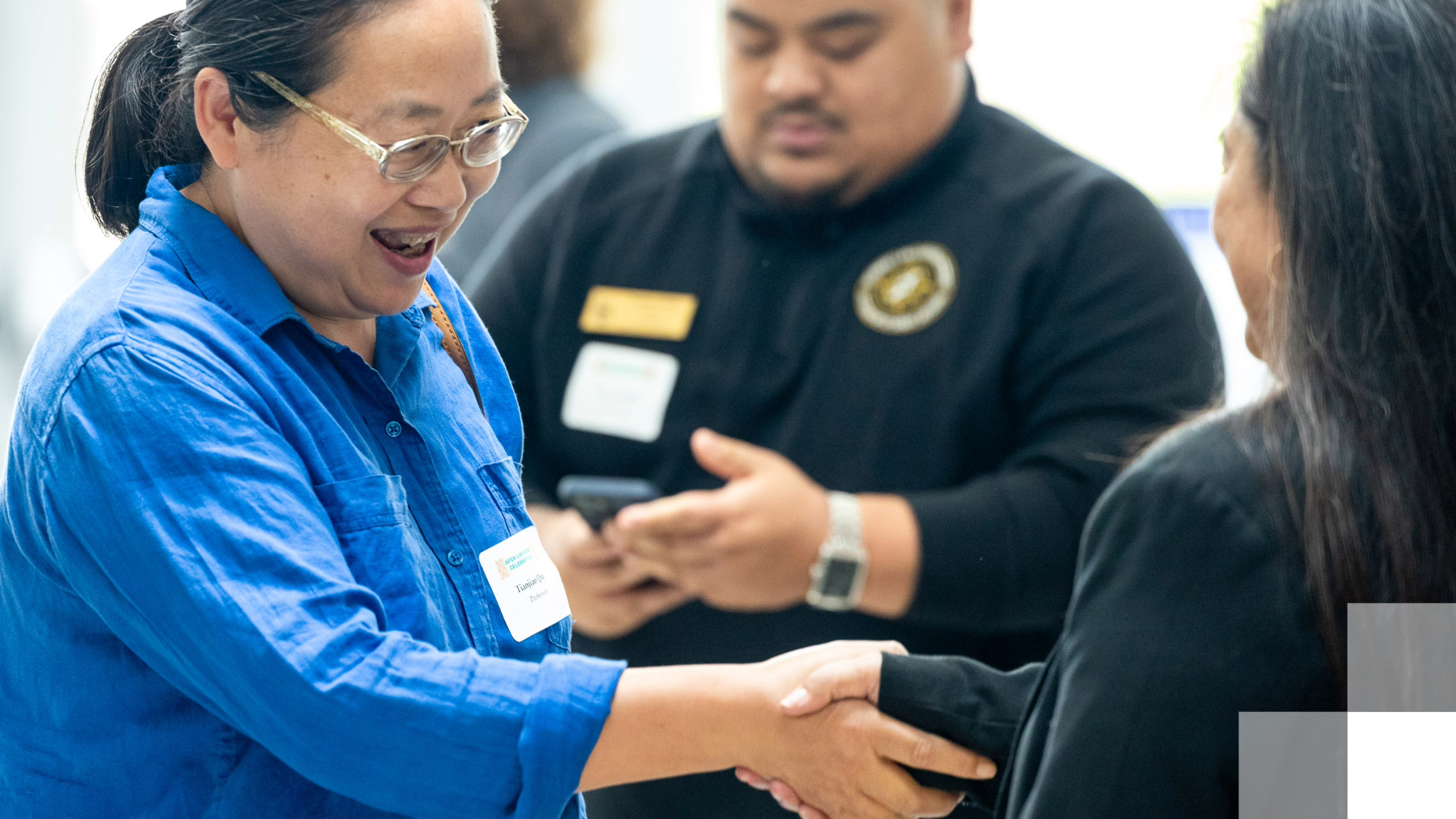 Partnership Database Two people shaking hands at an event