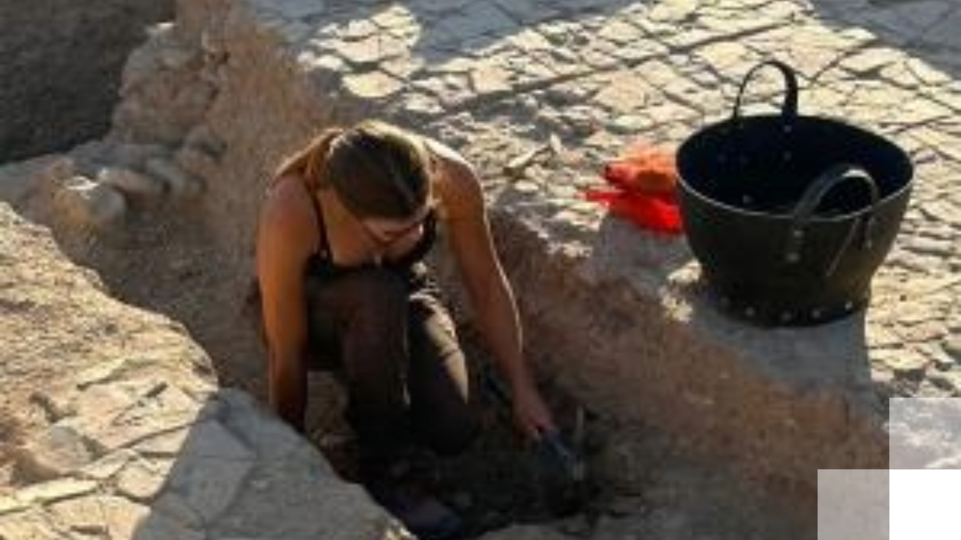Person excavating at an archaeological dig site Person excavating at an archaeological dig site