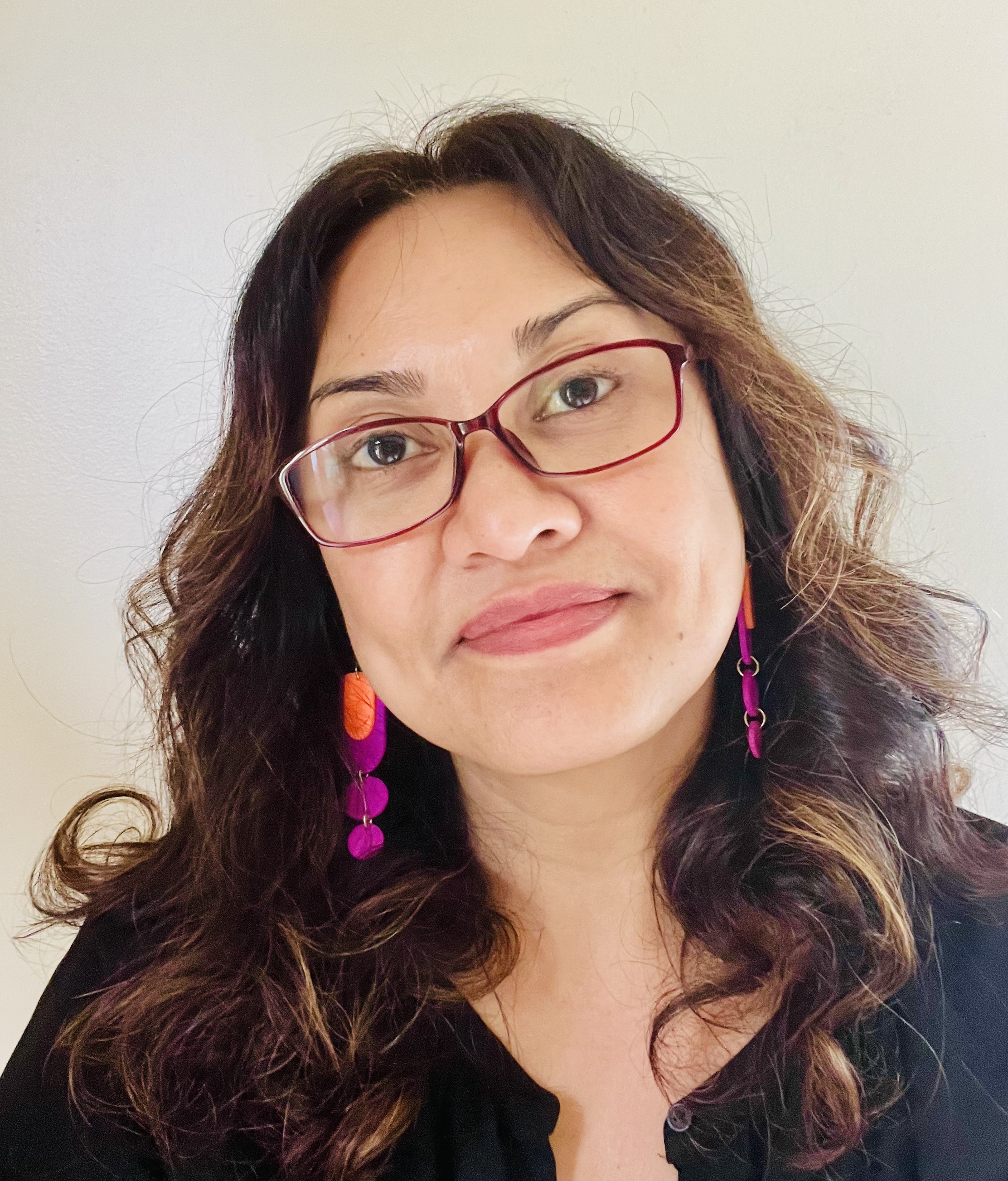person smiling towards camera with glasses