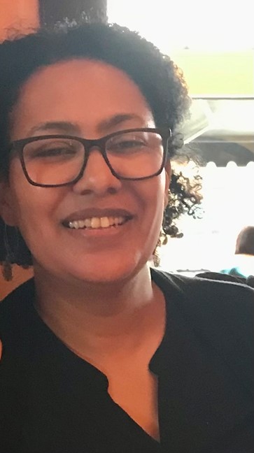 person smiling towards camera with glasses