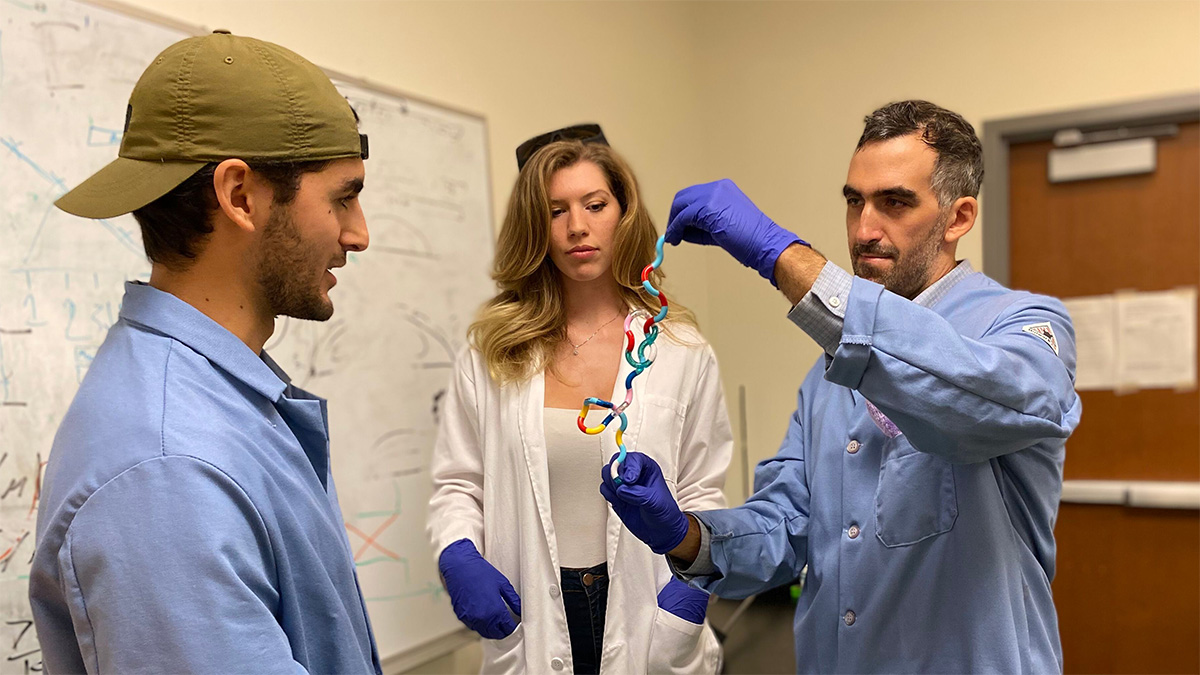 Dr. Klotz and student researchers viewing a knot