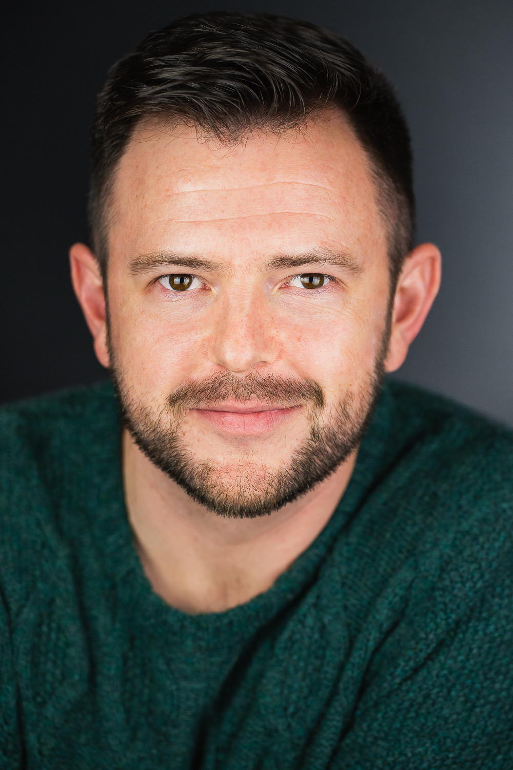 a man smiles into the camera
