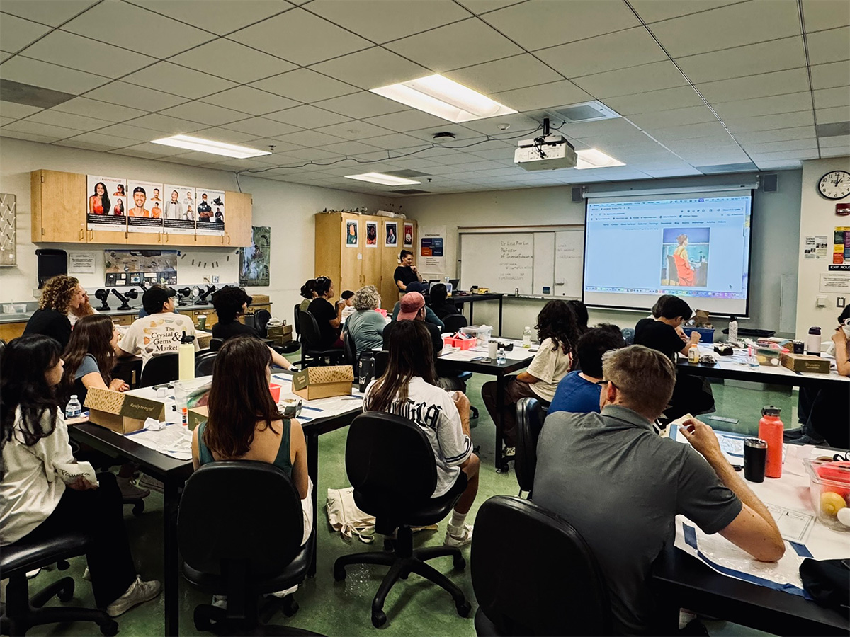 students listening to a presentation about painting