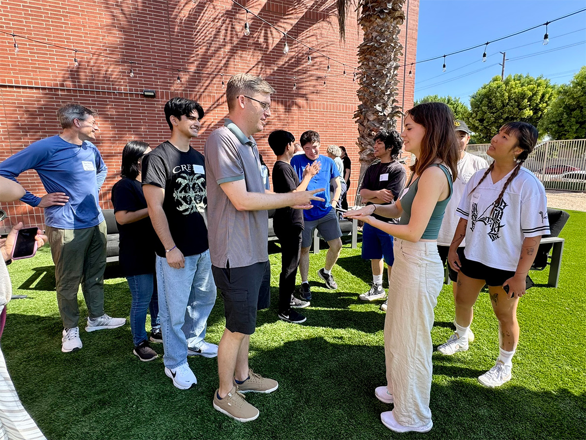 students and faculty playing rock-paper-scissors