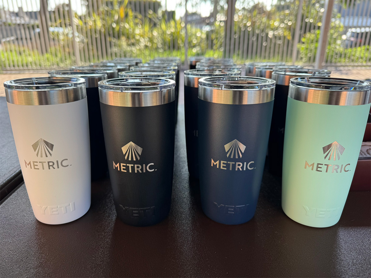 metal liquid containers with METRIC branding