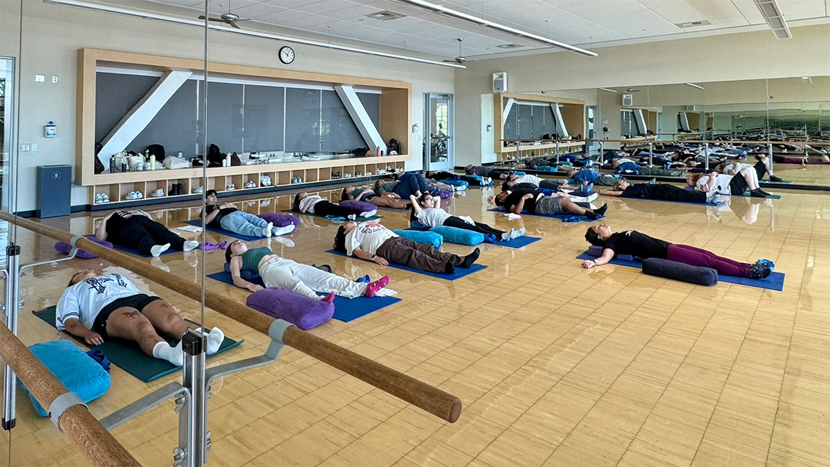 students laying flat during a yoga session