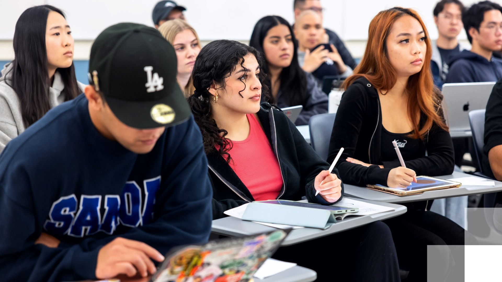 Financial Education Initiative Students attentively taking notes in a classroom