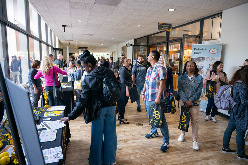 group browsing tables at resource fair