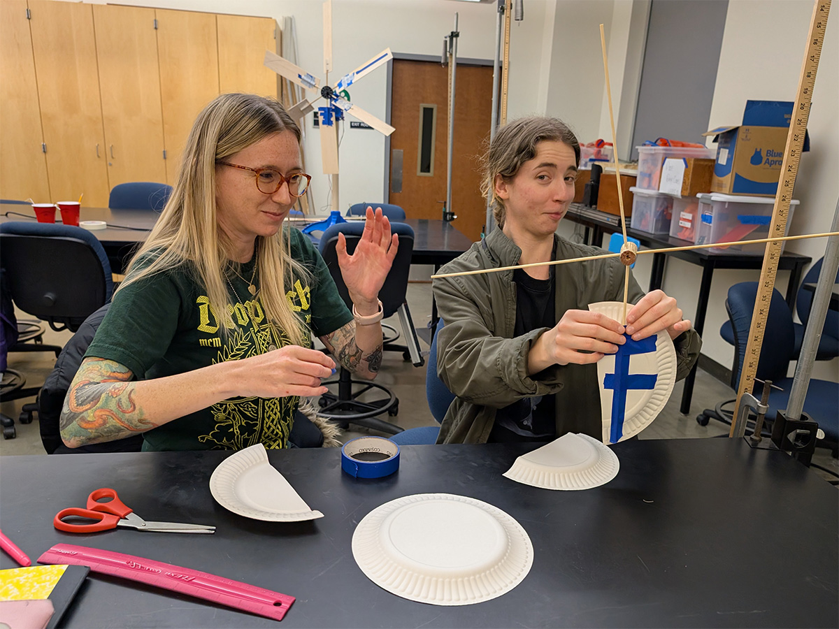 students constructing a windmill with crafty materials