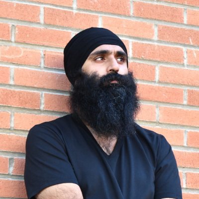 Dr. Judge leaning against a brick wall