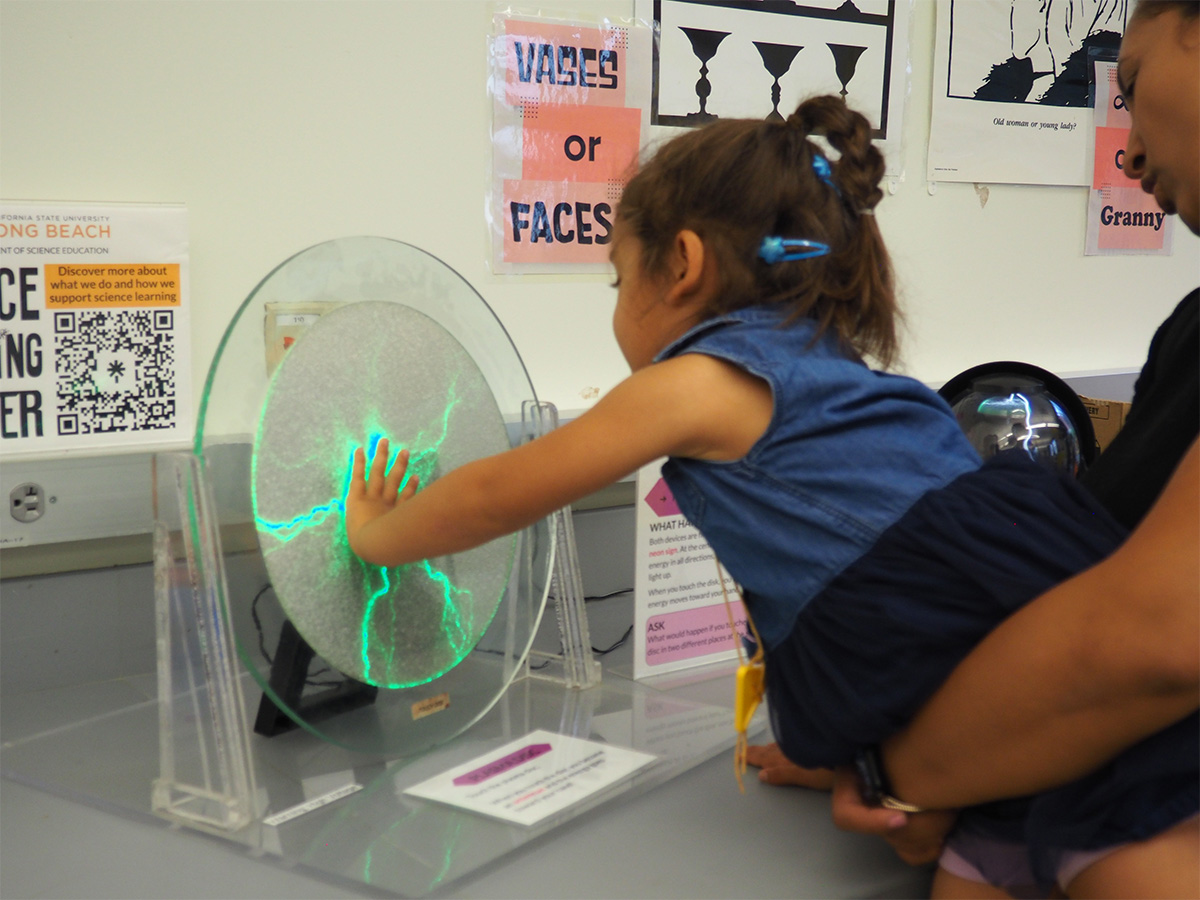 young child touching a plasma plate