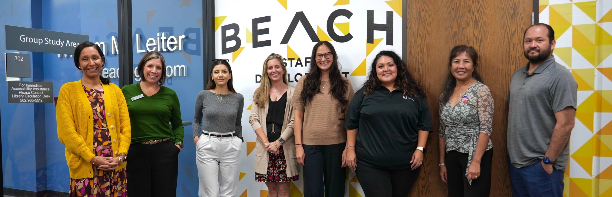8 people standing in front of group study area