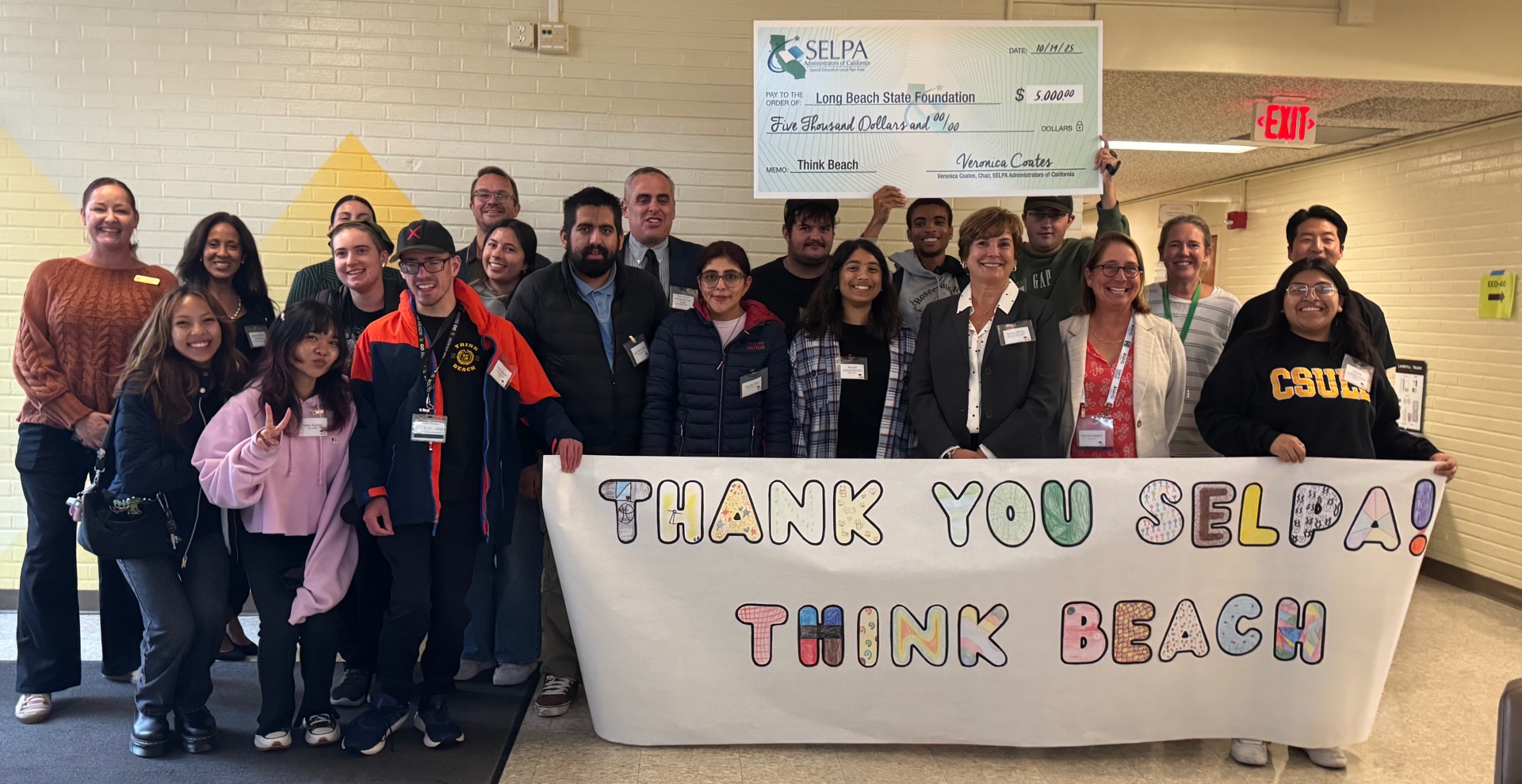 Think Beach students and mentors pose for a photo with a $5,000 check