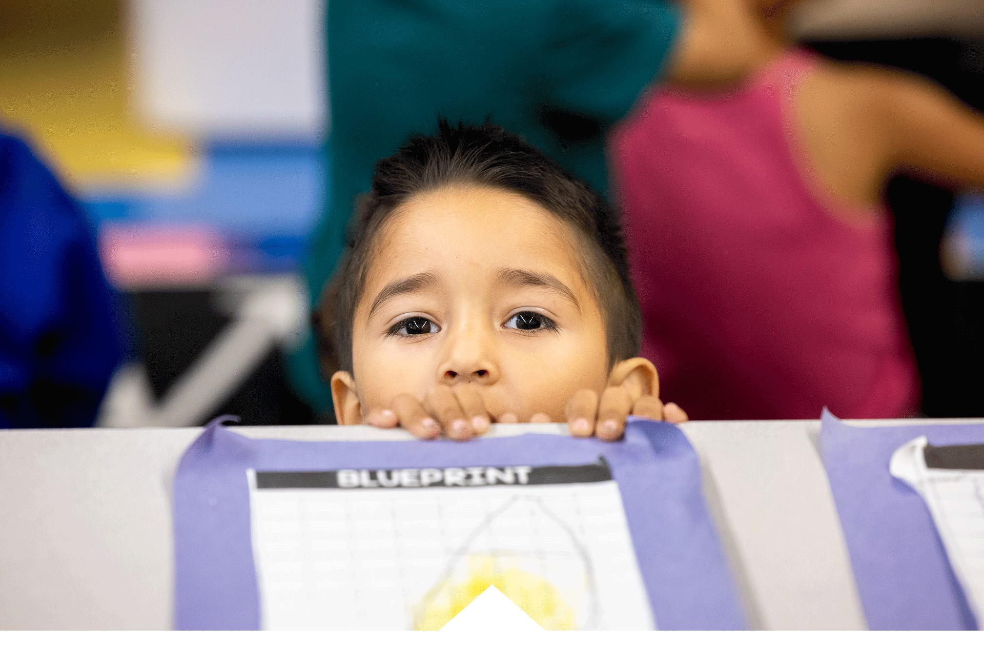 student peaking over desk