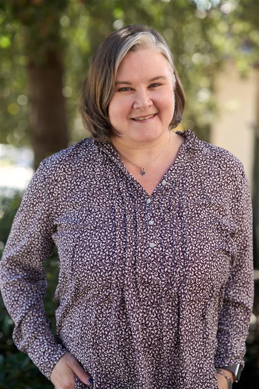 Megan looks towards the camera and smiles