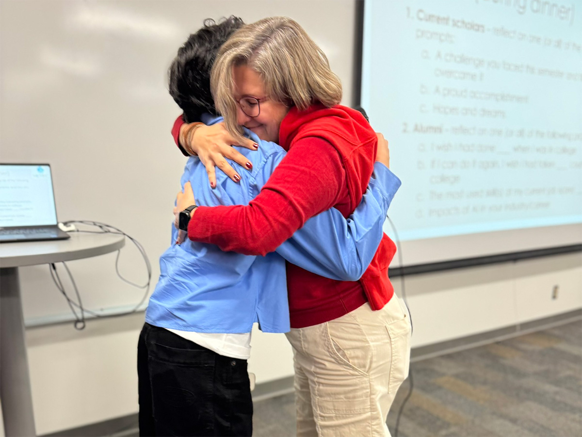 mentor and mentee sharing a hug