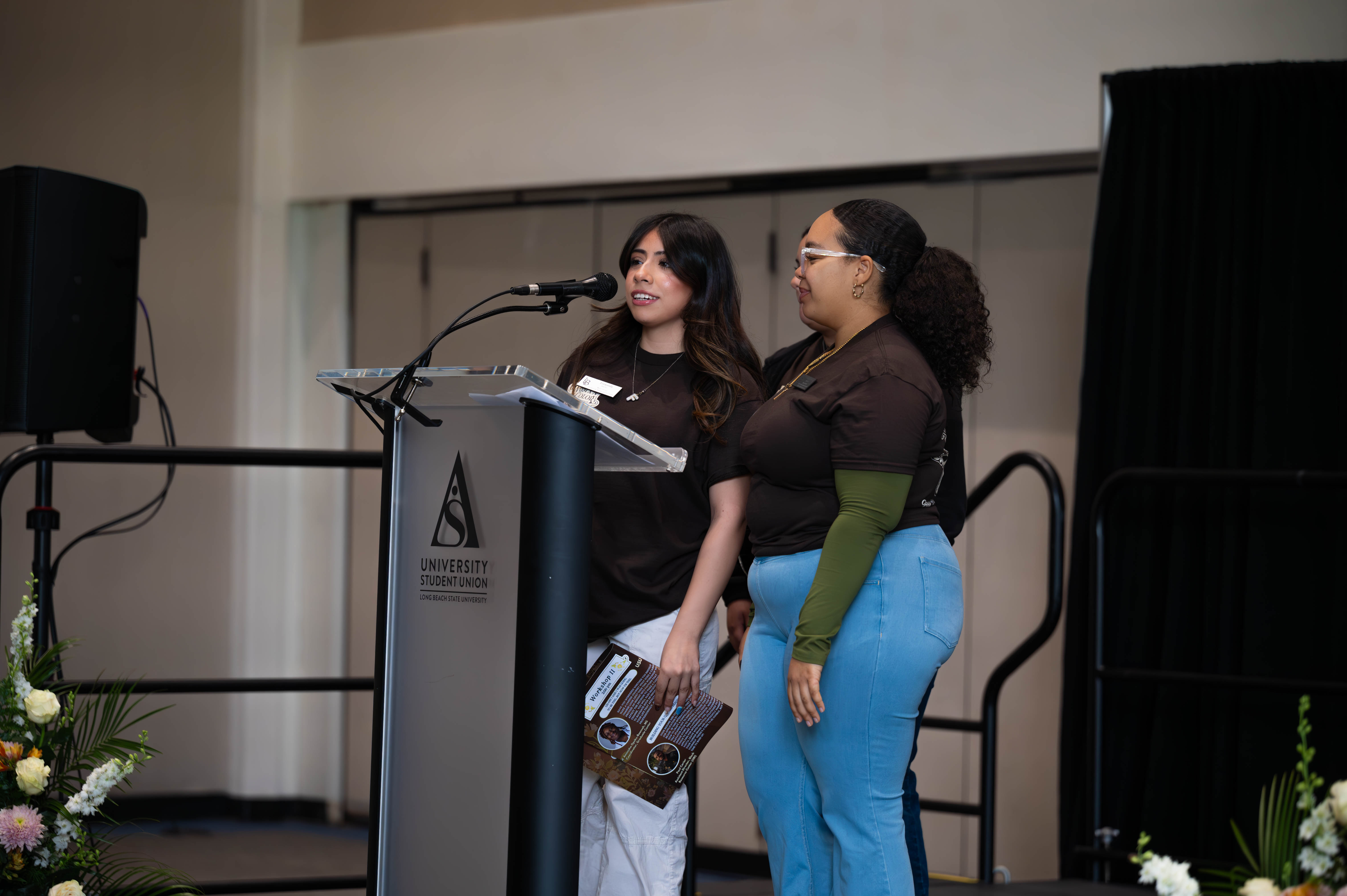 Two speakers presenting at the 2025 WOC Leadership Conference.