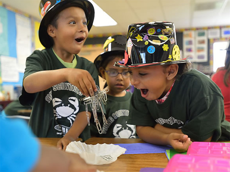 young children excited by magnetized paper clips