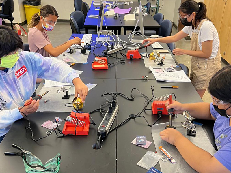 kids using soldering tools to construct a project