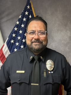 Lieutenant Leyva headshot in front of American flag.