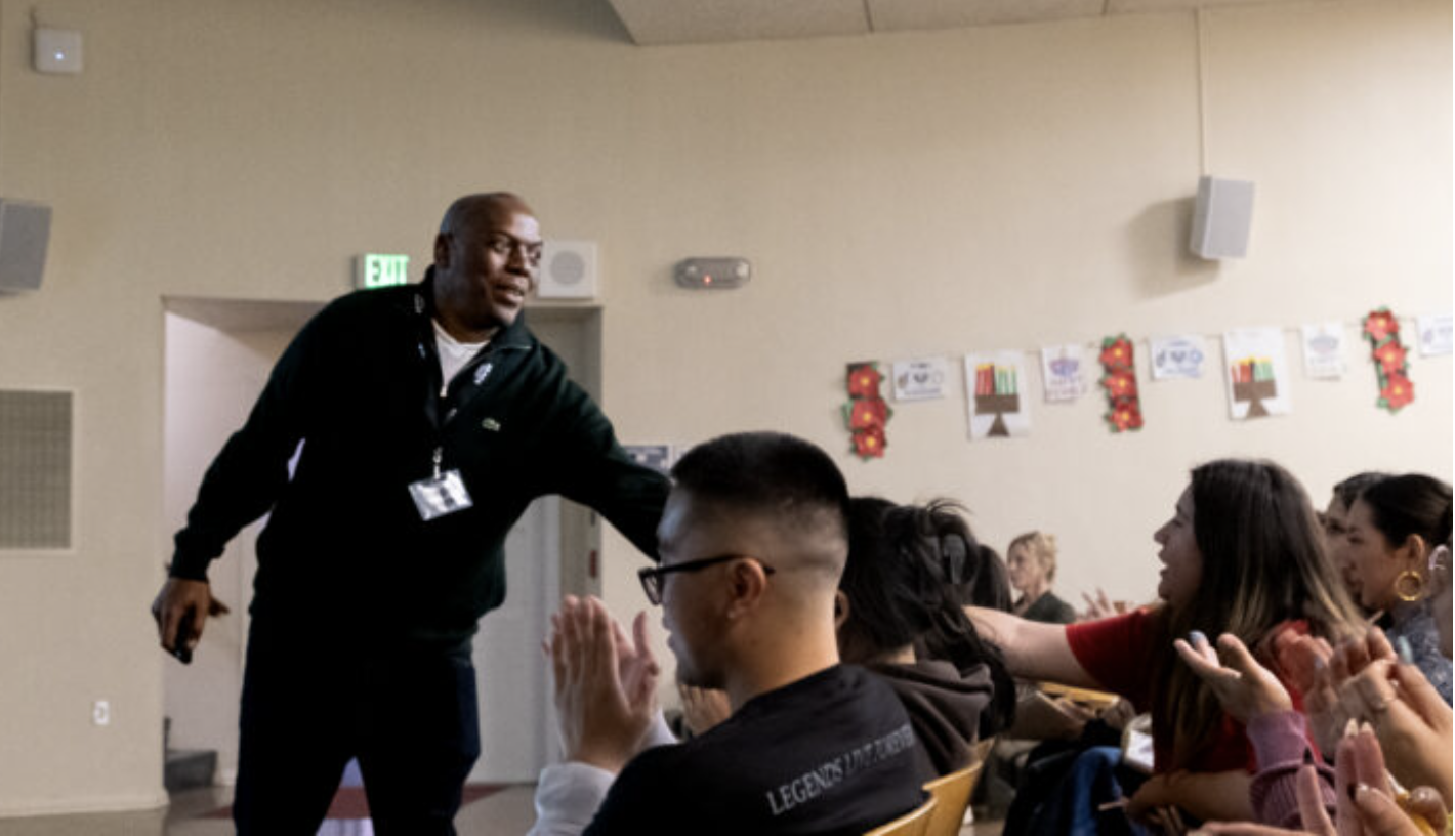 Speaker, Regis Inge, interacts with audience.