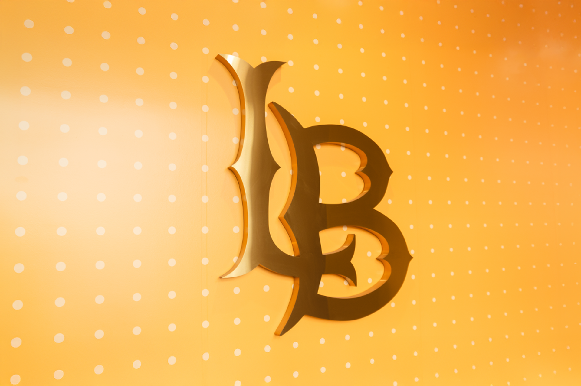 Gold Long Beach L B on a yellow background