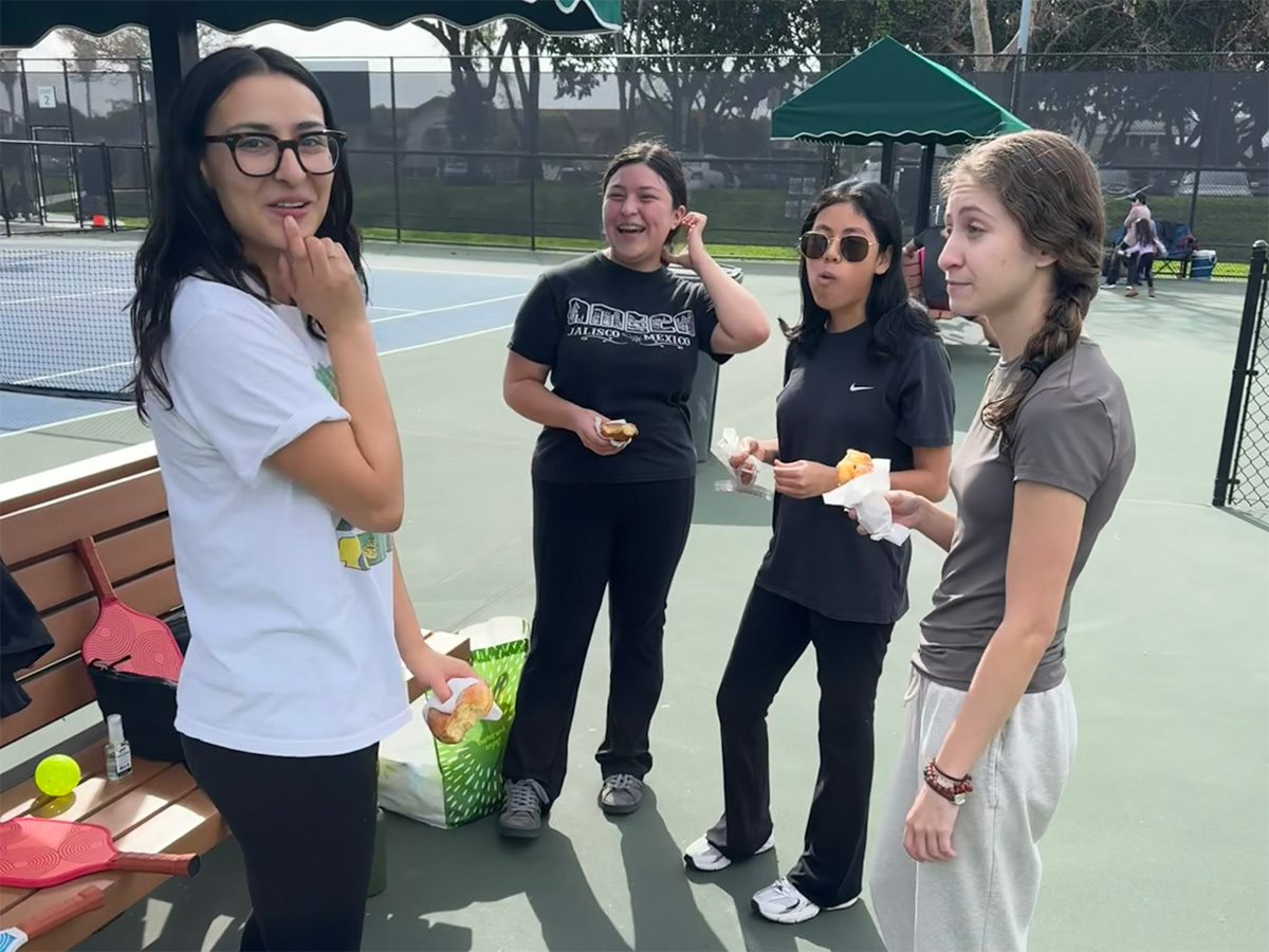 people chatting and eating donuts