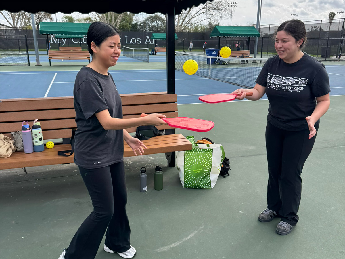 people bouncing balls on paddles