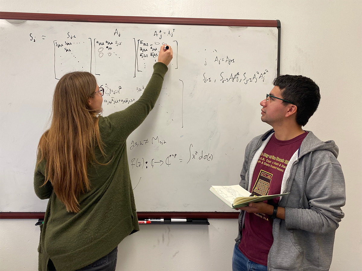 Kathryn McCormick writing a calculation