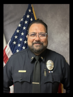 Lieutenant Leyva headshot in front of American flag.