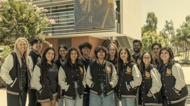 a group of students in a line wearing letterman jackets