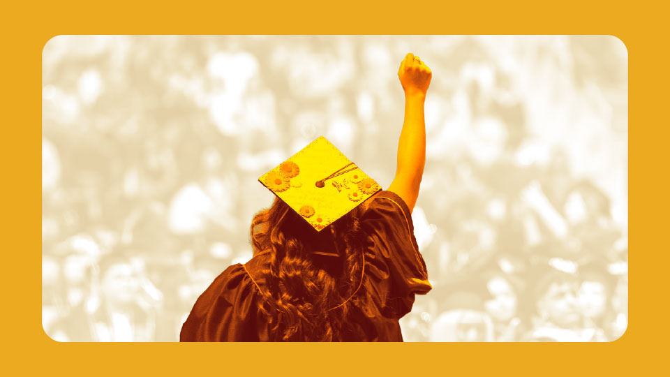 Commencement student with hand in the air