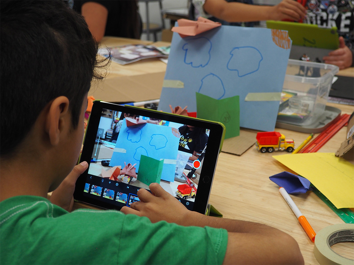 young child using tablet to create stop motion video