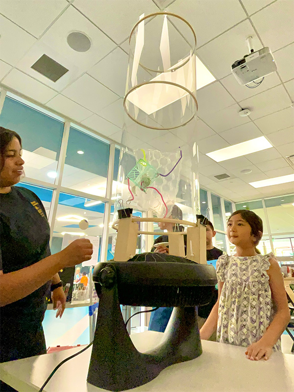 crafted object being suspended in small wind tunnel