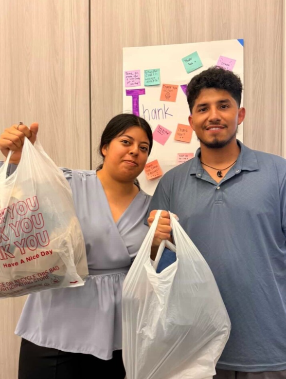 Two students with bags of clothes