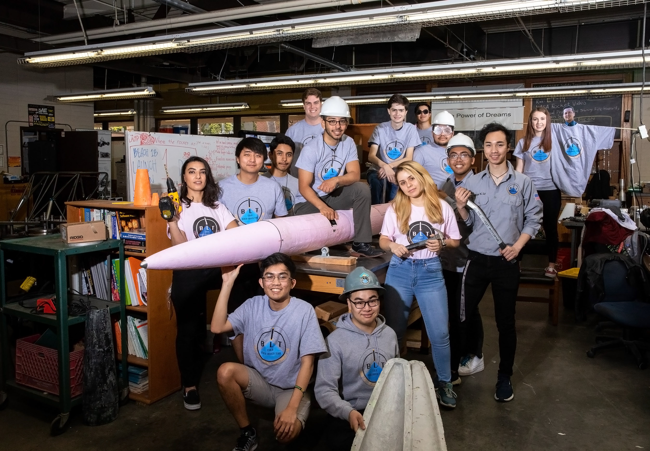 Students pose with pink rocket