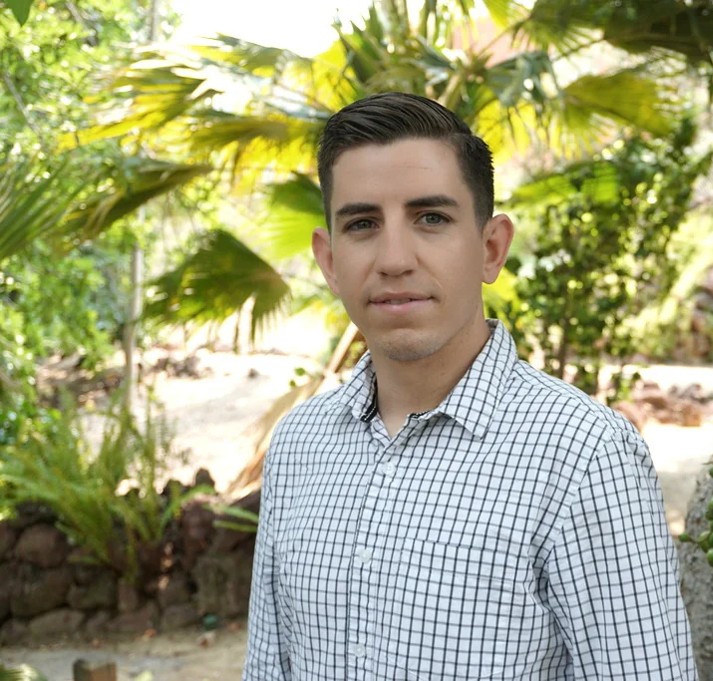 Jesus Plascencia in front of greenery