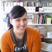 Stacia Samartan in front of a bookshelf