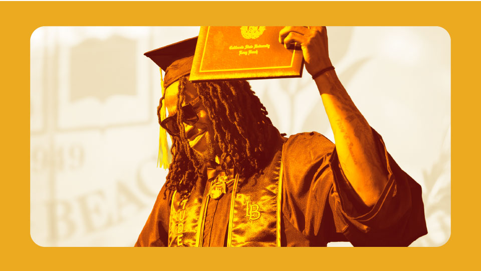 Commencement student holding diploma
